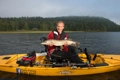 An angler with a Pike caught from the Hobie Pro Angler 14 kayak
