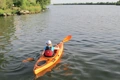 The Riot Edge 11 touring kayak being paddled along a gentle river