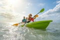 The Feelfree Corona Kayak being paddled by a family at the beach