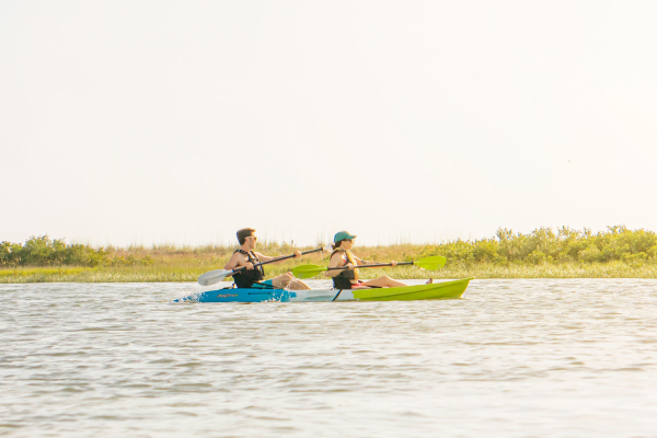 The Feelfee Gemini Sport Two Person Kayak shown paddling along a river