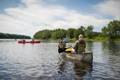 The Old Town Discovery 158 shown with paddler casting a fishing line