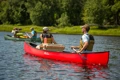 The Old Town Discovery Canoe shown being paddled along a river